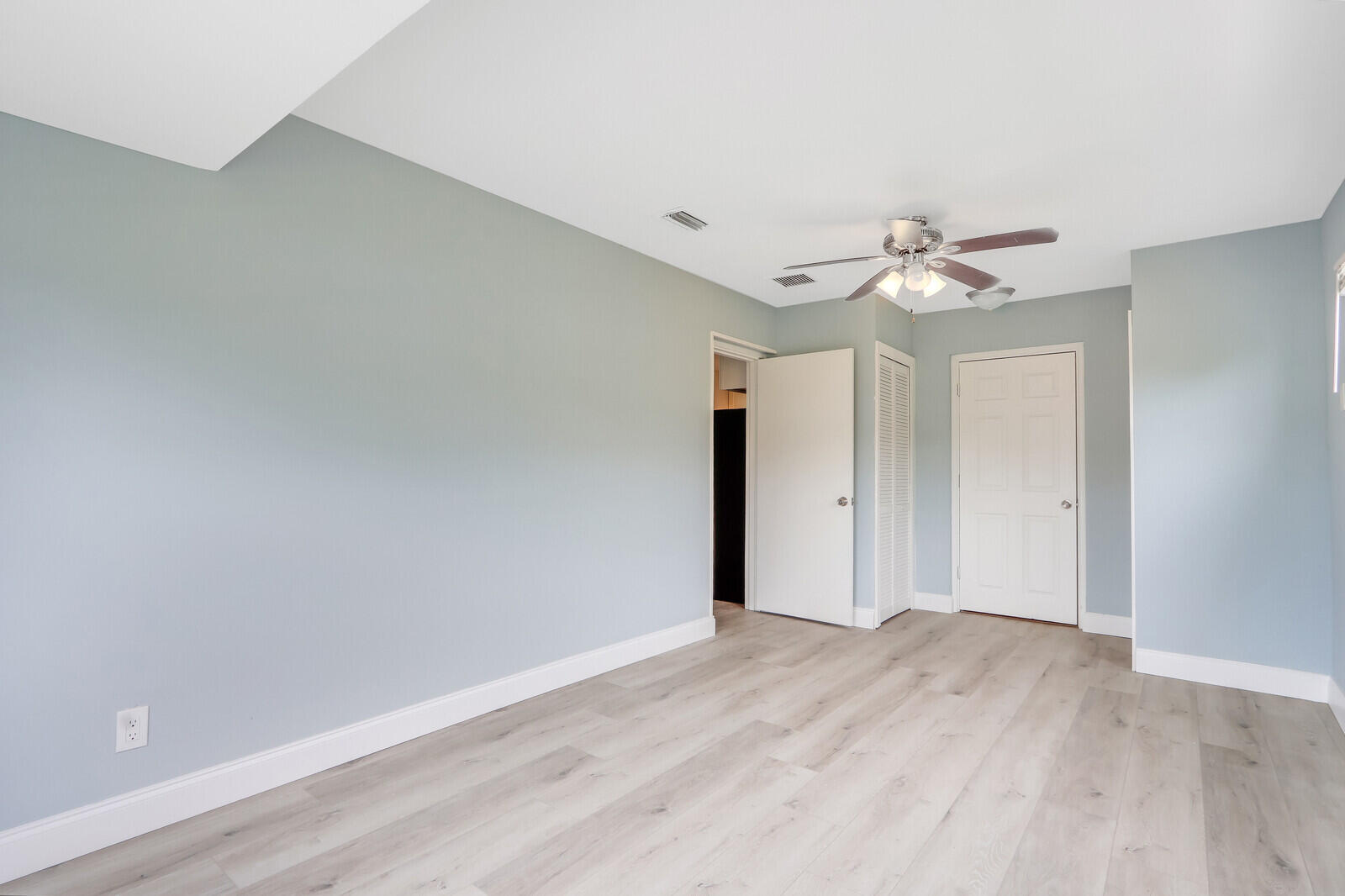 3852 Gull Road Palm Beach Gardens, FL 33410 - Photo 21 of 30 a view of an empty room with a chandelier fan