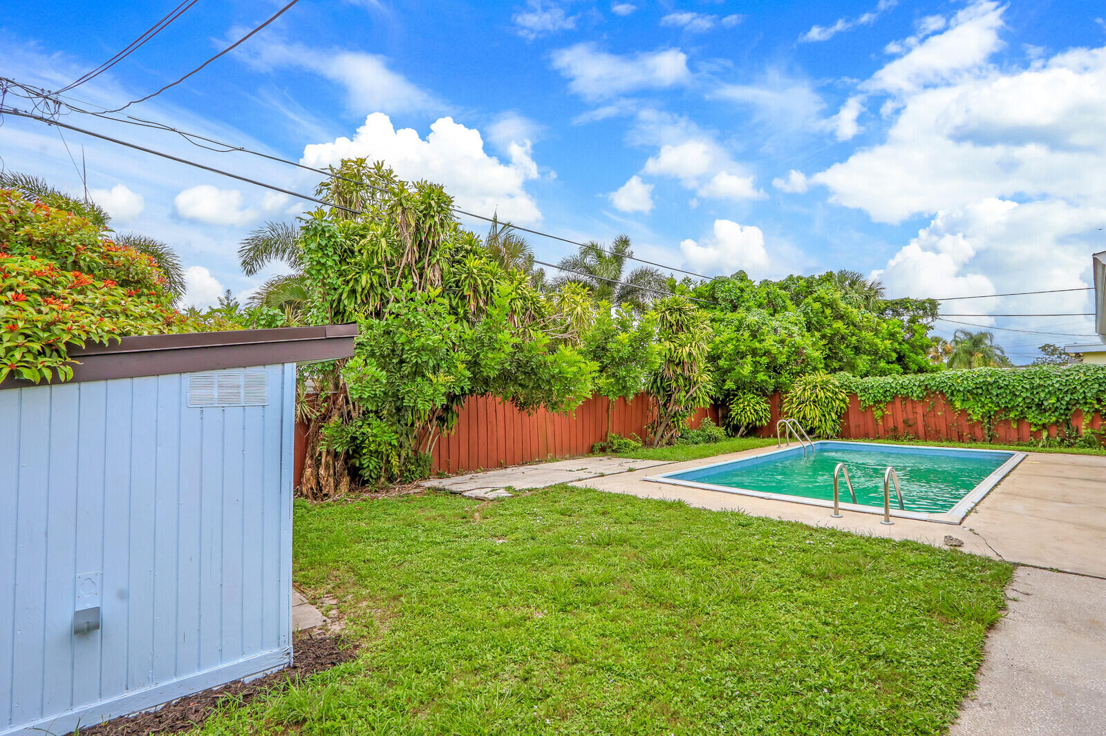 3852 Gull Road Palm Beach Gardens, FL 33410 - Photo 25 of 30 a view of a backyard with potted plants and a fountain