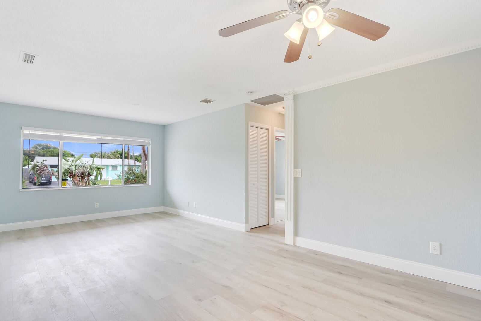 3852 Gull Road Palm Beach Gardens, FL 33410 - Photo 6 of 30 an empty room with windows and fan