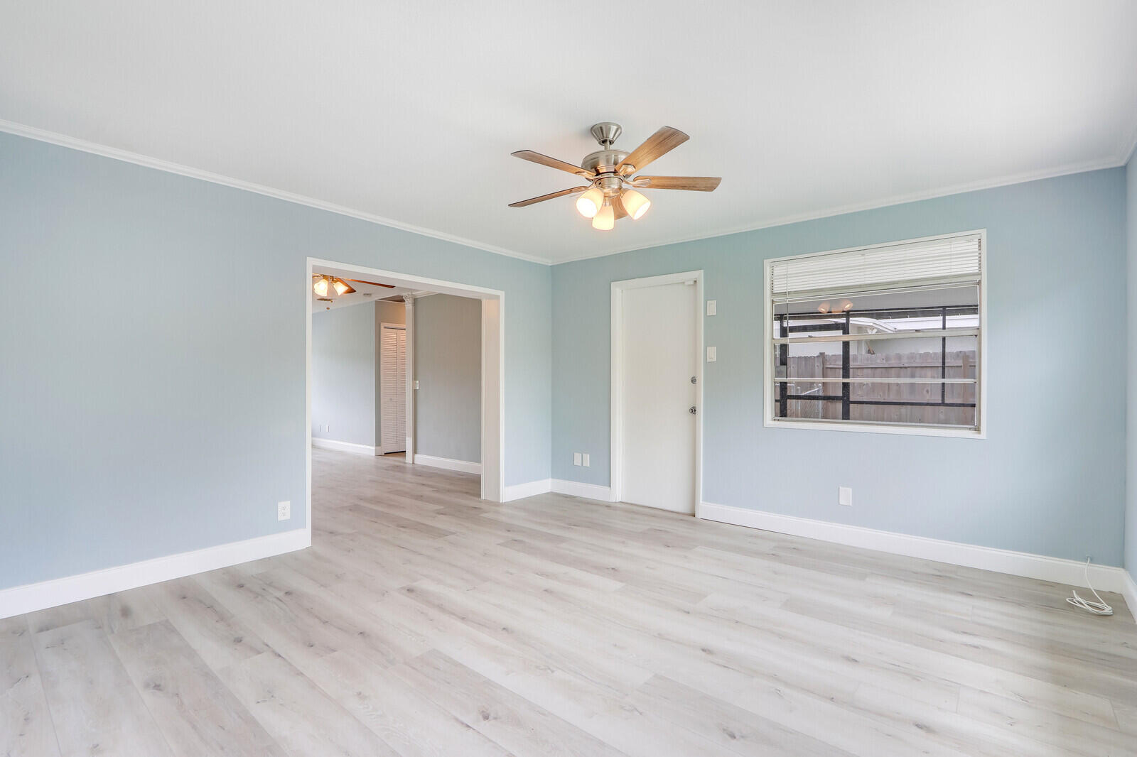 3852 Gull Road Palm Beach Gardens, FL 33410 - Photo 8 of 30 a view of empty room with wooden floor and fan