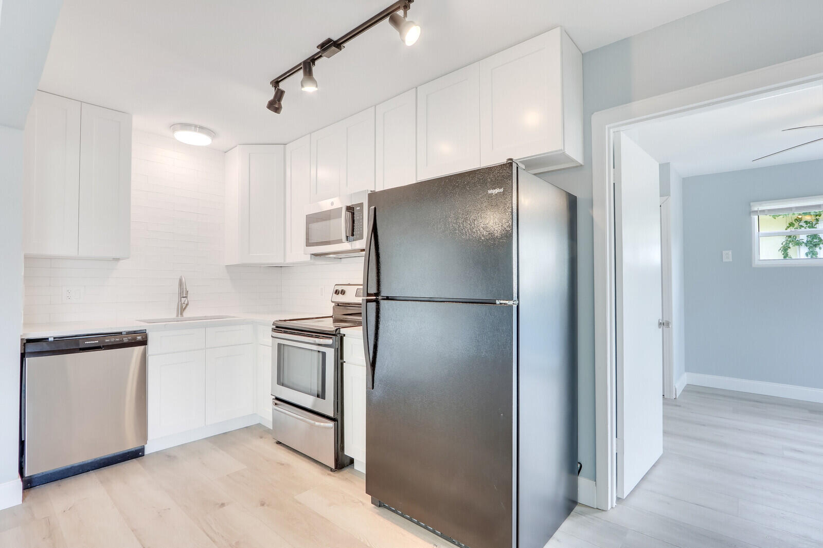 3852 Gull Road Palm Beach Gardens, FL 33410 - Photo 10 of 30 a kitchen with stainless steel appliances granite countertop a refrigerator and a sink