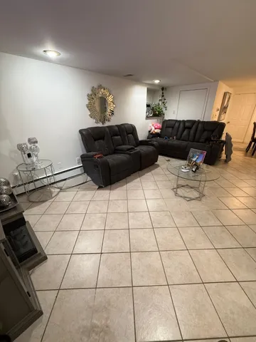 a living room with furniture and flowers