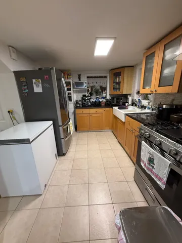 a kitchen with stainless steel appliances a refrigerator sink and cabinets