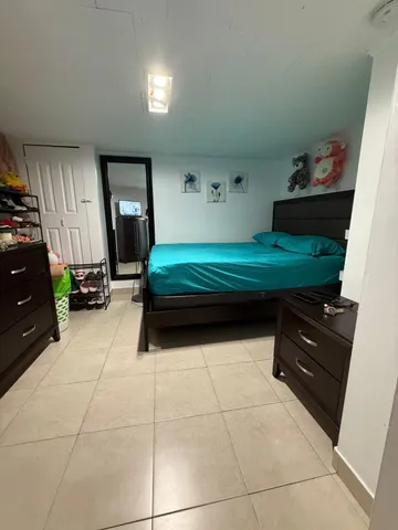 a bedroom with a bed and a dresser