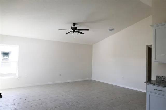 a view of a livingroom with a ceiling fan and window
