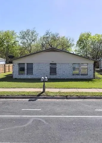 a view of a house with a swimming pool and a yard