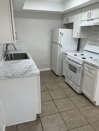 a kitchen with a stove top oven and cabinets