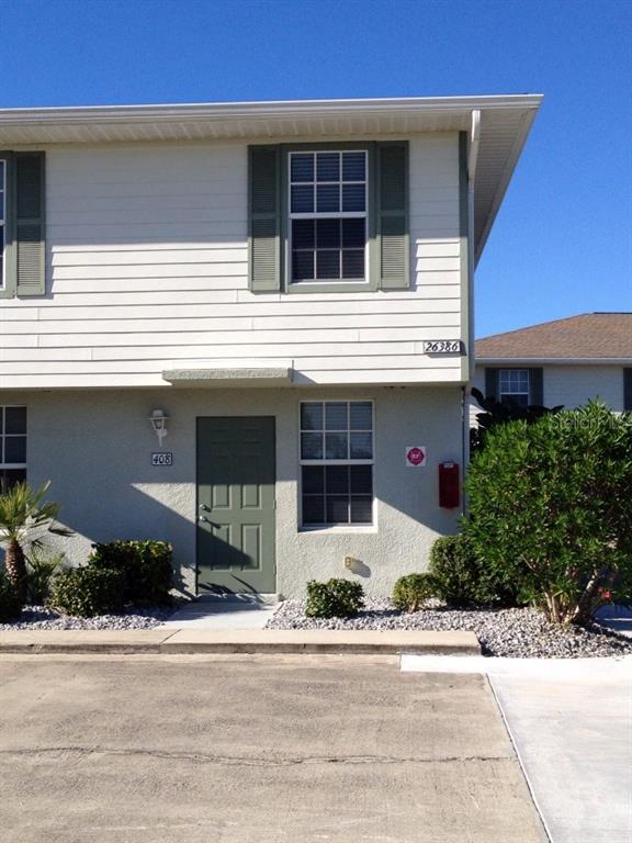 26386 Nadir Road, Unit 408 Punta Gorda, FL 33983 - Photo 1 of 1 Front door view of end unit within walking distance to the pool, and close to great walking area for two pets that are allowed in this complex.