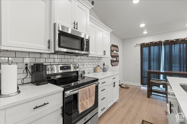 464 South Trejo Rdg Road Grantsville, UT 84029 - Photo 11 of 33 Kitchen with stainless steel appliances, backsplash, recessed lighting, white cabinets, and baseboards