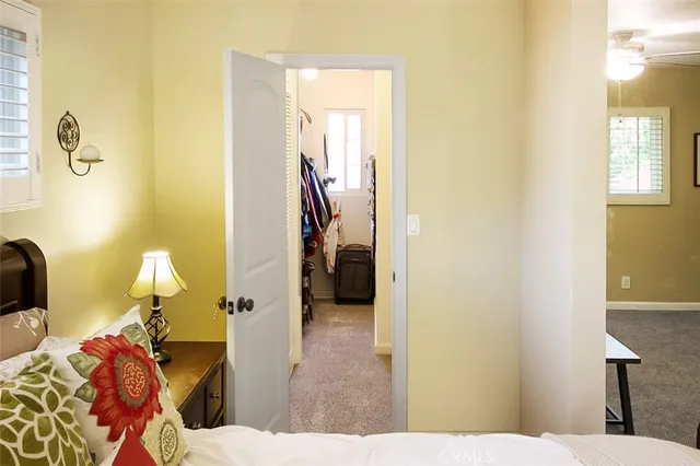 a bedroom with a bed and a lamp on the table