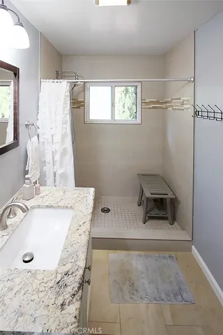 a bathroom with a sink toilet and mirror