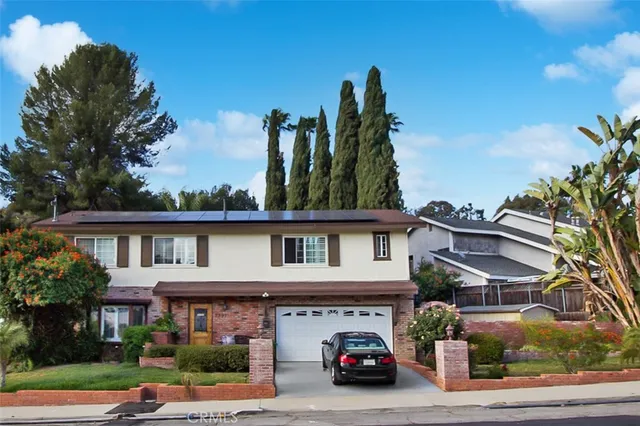 a view of a car park in front of house