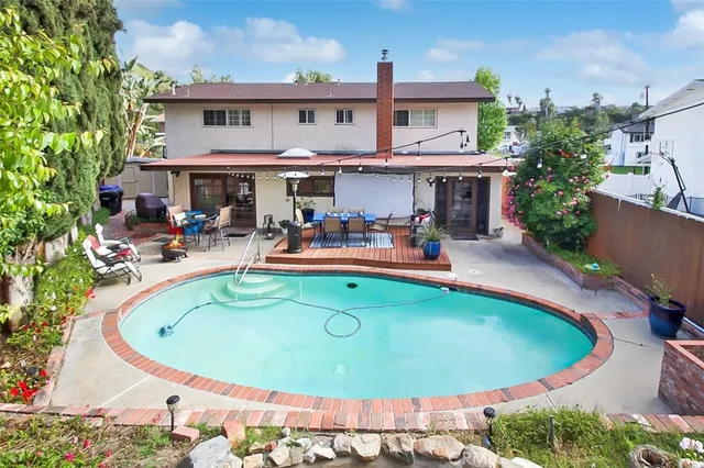 a view of a swimming pool with outdoor seating