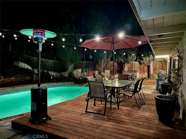 a view of a patio with dining table and chairs