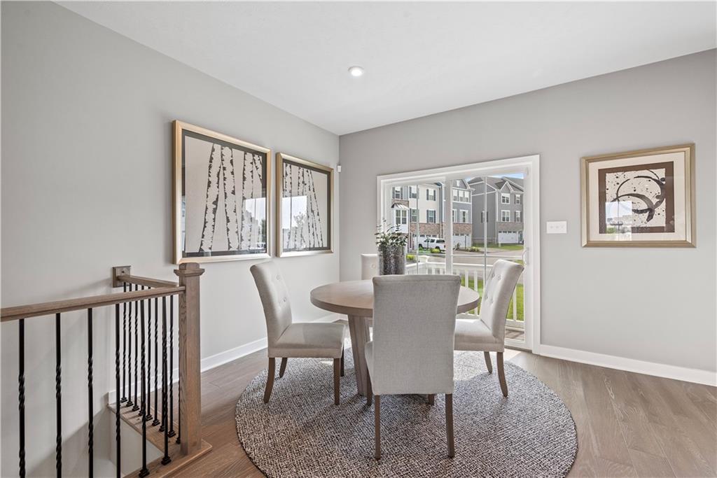 8100 Walnut Way Gibsonia, PA 15044 - Photo 13 of 40 a view of a dining room with furniture a couch and wooden floor