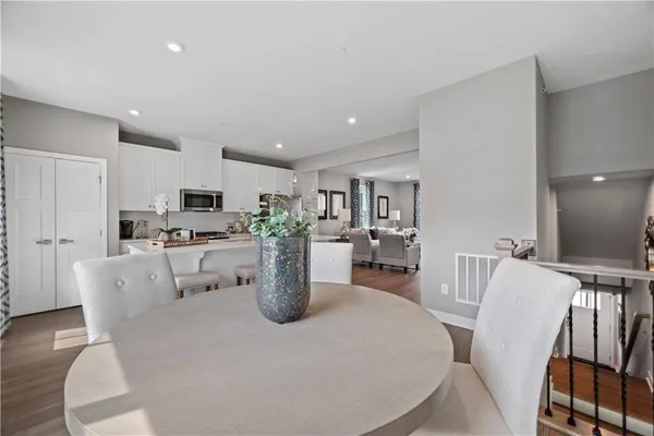a dining room with furniture a window and kitchen view