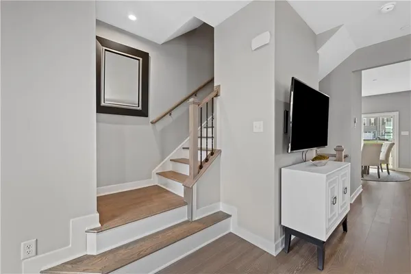 a living room with a flat screen tv and a rug