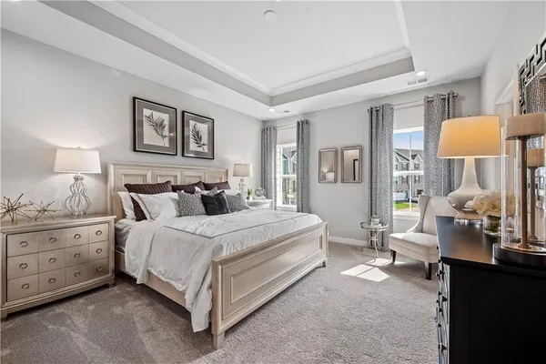a spacious bedroom with a bed and window
