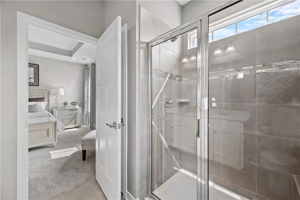 a bathroom with a glass shower door and a toilet