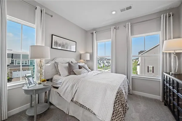 a bedroom with a bed a table and painting