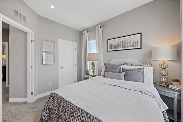 a bedroom with a bed and a lamp