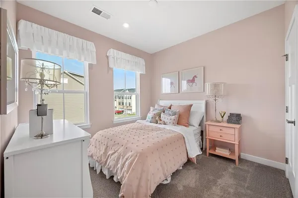 a bedroom with a bed and large windows