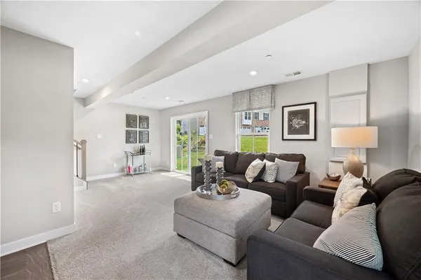 a living room with furniture and a lamp