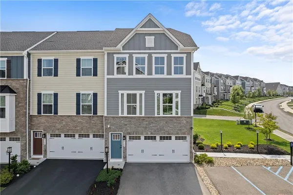 a view of a big house with a yard