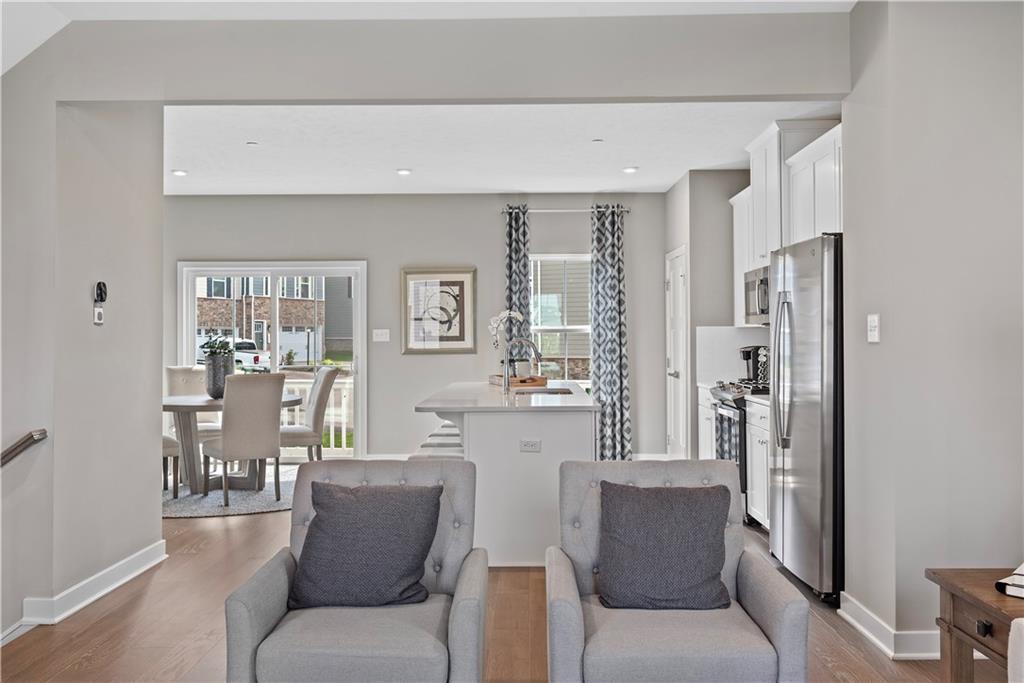 8100 Walnut Way Gibsonia, PA 15044 - Photo 6 of 40 a living room with furniture a large window and a wooden floor