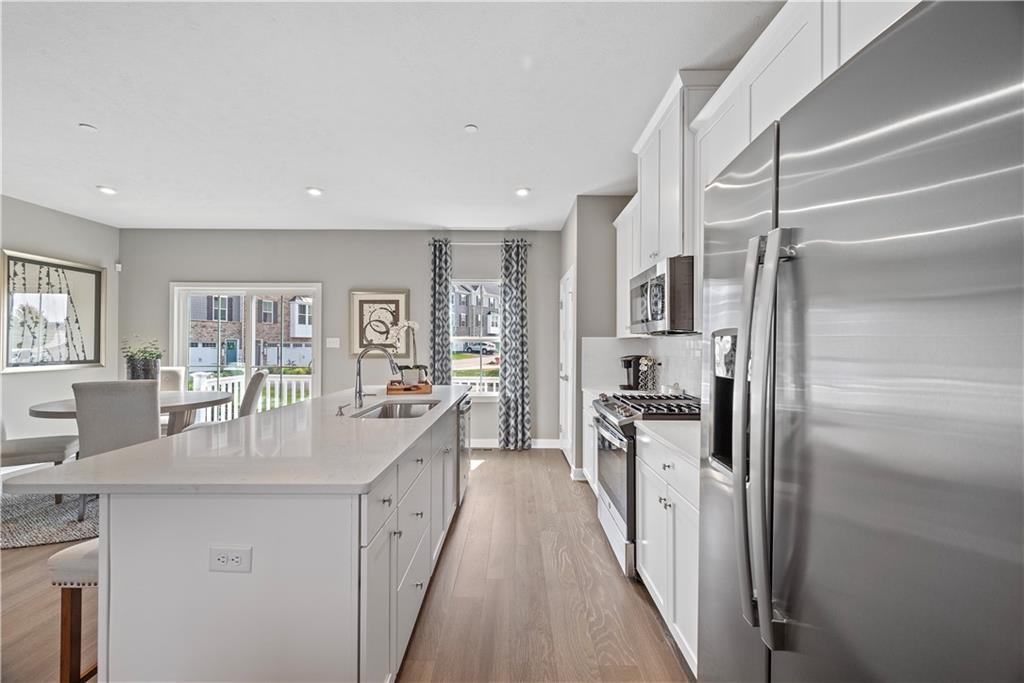 8100 Walnut Way Gibsonia, PA 15044 - Photo 9 of 40 a kitchen with stainless steel appliances granite countertop a refrigerator a stove and a sink
