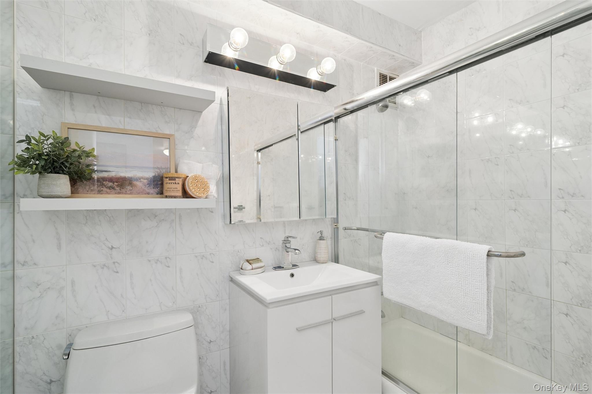 522 Shore Road, Unit 5P Long Beach, NY 11561 - Photo 9 of 26 Updated bathroom with glass shower doors