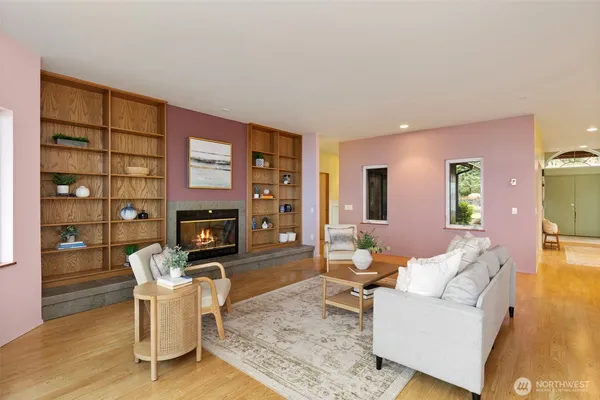 a living room with furniture a fireplace and a flat screen tv