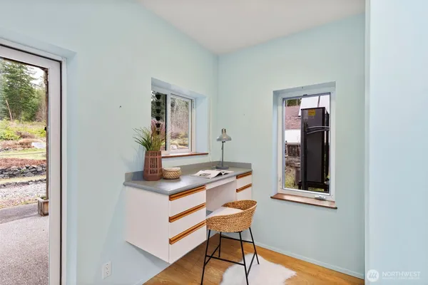 a workspace with wooden floor and a bathroom