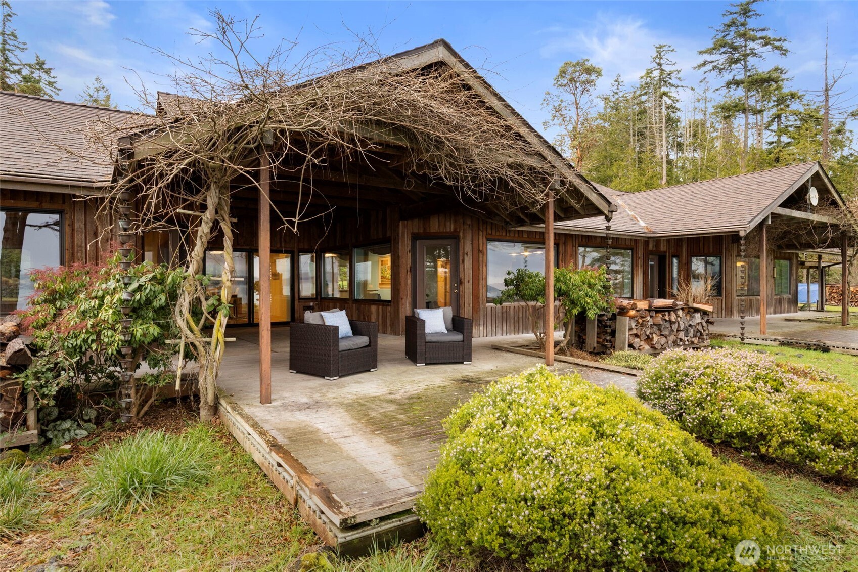 824 Schwartz Road Nordland, WA 98358 - Photo 24 of 40 a view of a patio with table and chairs potted plants