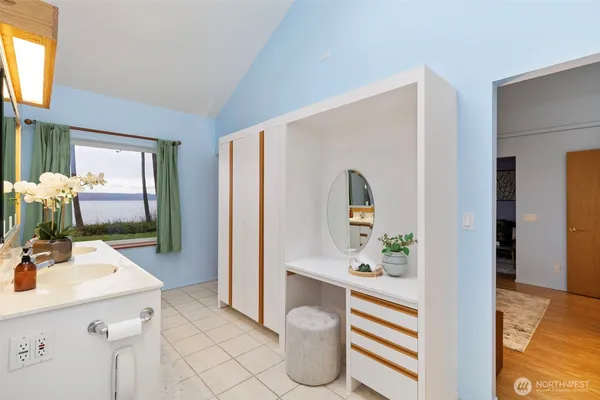 a bathroom with a sink a mirror and a shower