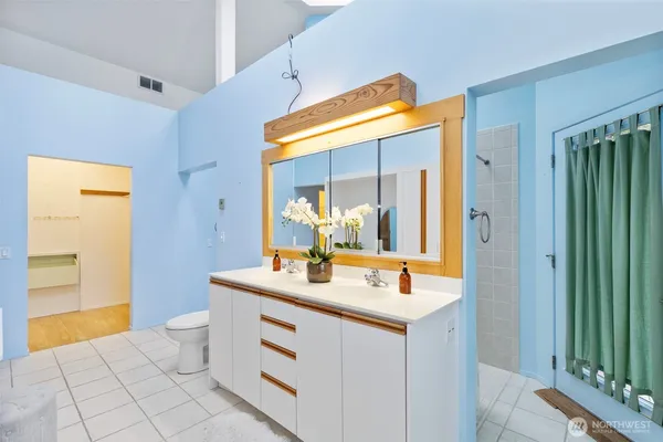 a bathroom with a sink mirror and a bathtub