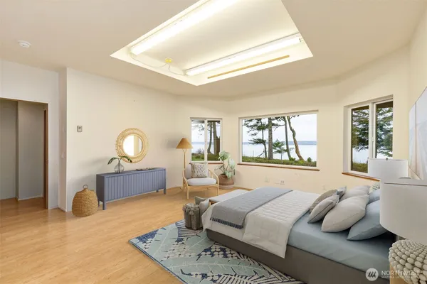 a bedroom with a bed a window and dresser