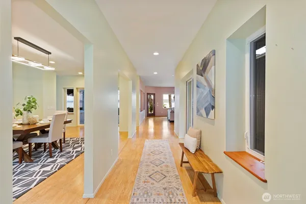 a hallway with furniture and wooden floor