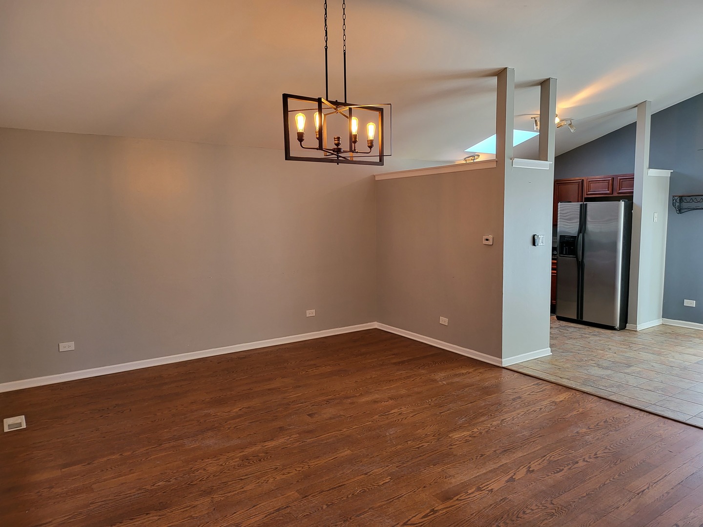 61 White Oaks Road Matteson, IL 60443 - Photo 4 of 4 an empty room with wooden floor and windows