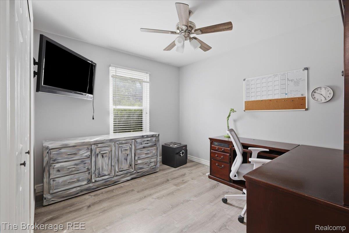 11282 Silver Lake Road Byron, MI 48418 - Photo 15 of 32 Wood-finish flooring, ceiling fan with integrated lighting, window with blinds, and light-toned wall paint