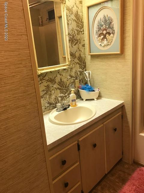 470 Baker Road Merritt Island, FL 32953 - Photo 11 of 21 a bathroom with a sink and a mirror