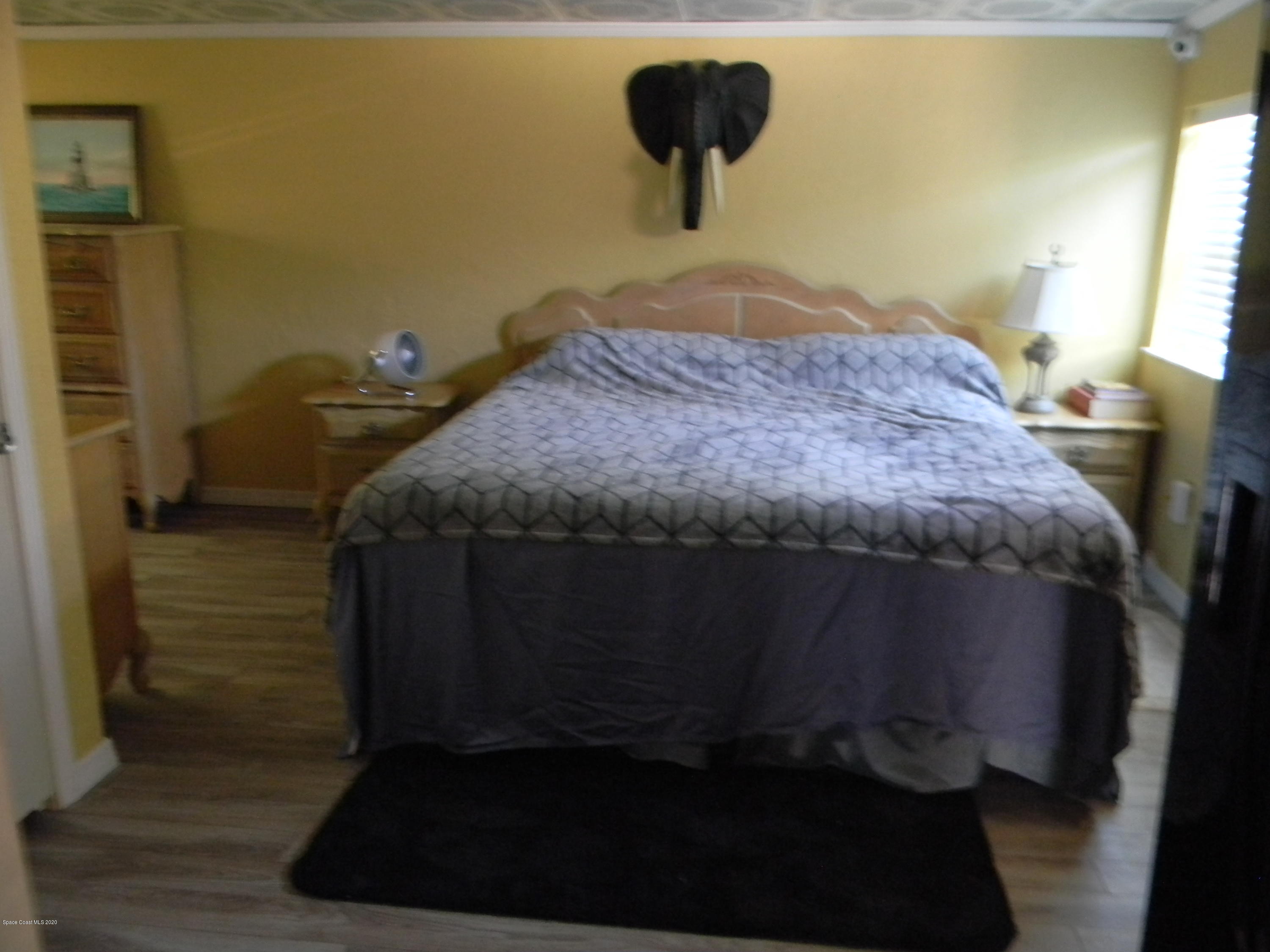 470 Baker Road Merritt Island, FL 32953 - Photo 13 of 21 a bedroom with a bed and a night stand