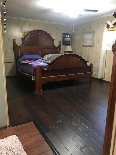 470 Baker Road Merritt Island, FL 32953 - Photo 16 of 21 a bedroom with a bed and a potted plant