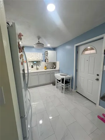 a kitchen with stainless steel appliances a refrigerator and a sink