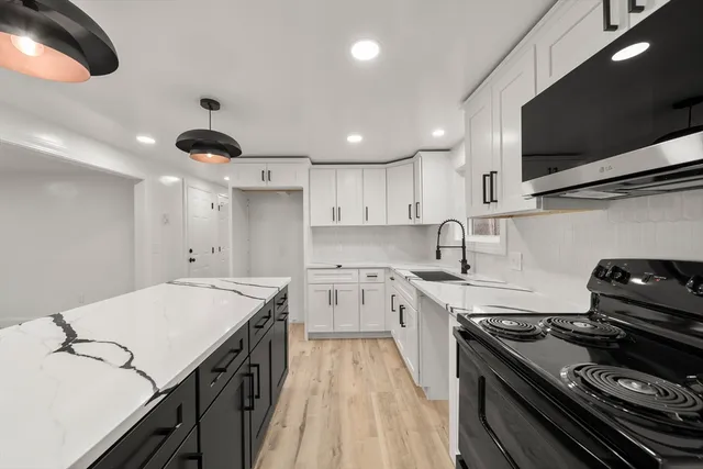 a kitchen with a stove and a sink
