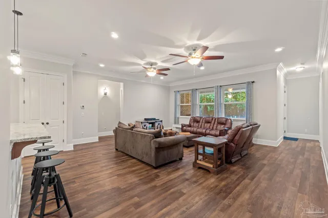 a living room with furniture and wooden floor
