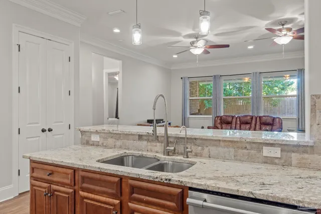 a kitchen with kitchen island a sink and a large window
