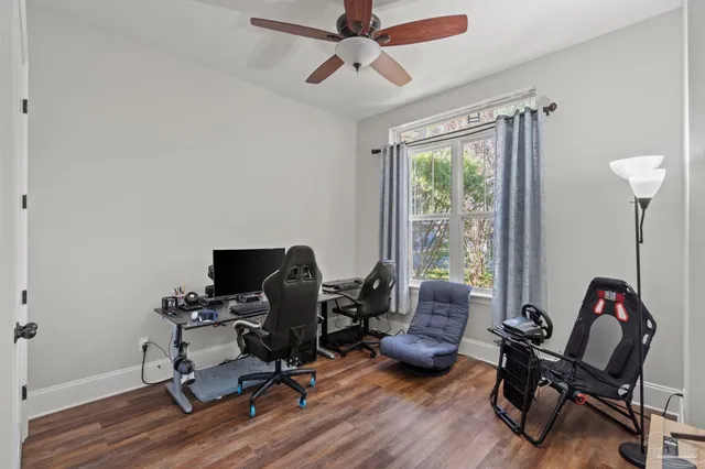 a view of a workspace with furniture and a window