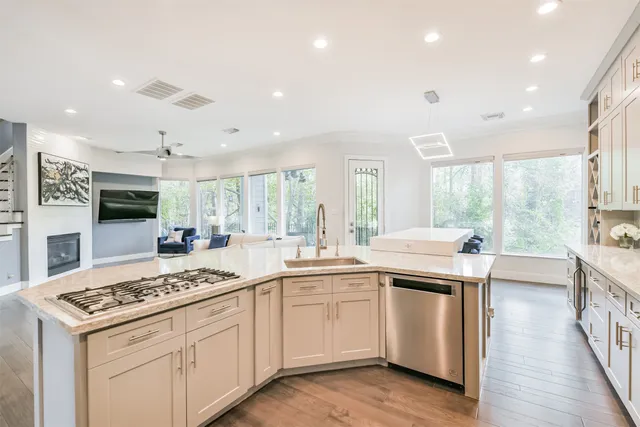 a kitchen that has a sink and a stove in it