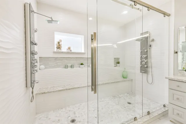 a bathroom with a shower and a sink